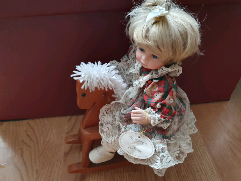 porcelain doll on rocking horse
